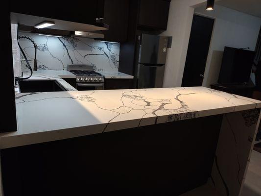 Kitchen countertop renovation with waterfall and full backsplash.