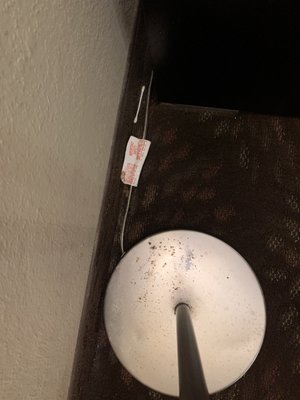 Dirty lamp base someone's  q tip on floor