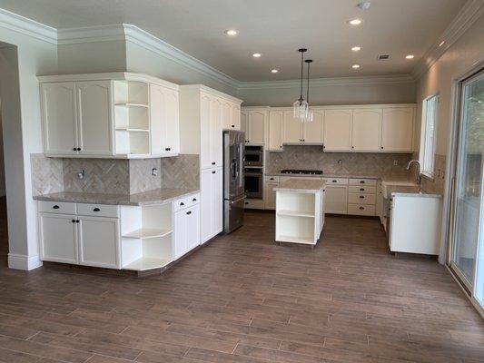 New finished kitchen remodel. Including painted cabinets, quartzite countertops, backsplash, and new can and pendant lights.