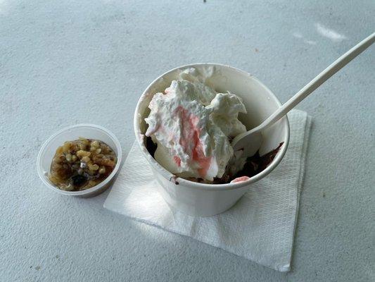 Hot fudge brownie sundae with a side of walnuts