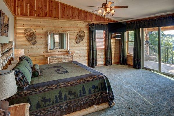 Master bedroom in the New Treetop Penthouse Suite features it's own deck with swingasan chairs and amazing views of Beaver Lake.