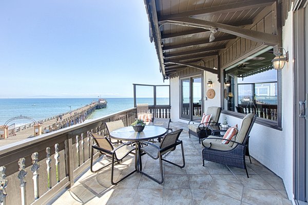 Deck with ocean and wharf views.