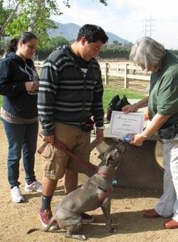 Silver and his parents celebrate his graduation from Good Dawg School!