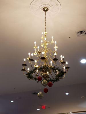 Dining room chandelier decorated for Christmas