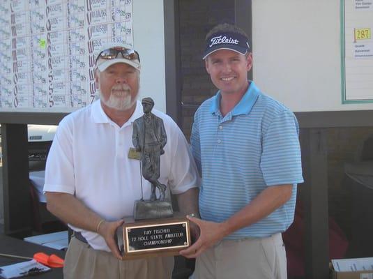 The 2011 Ray Fischer Tournament Champion, Miles McConnell.  Trophy presented by John Jensen.