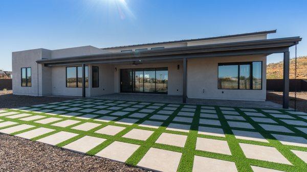 Checkerboard pavers with a covered patio.