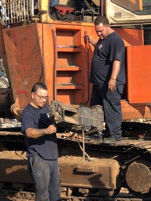 AAS techs hard at work off-site on excavation equipment