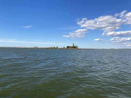 View from the ferry of an old picking/packing house that burned down.  Only the chimney remains.