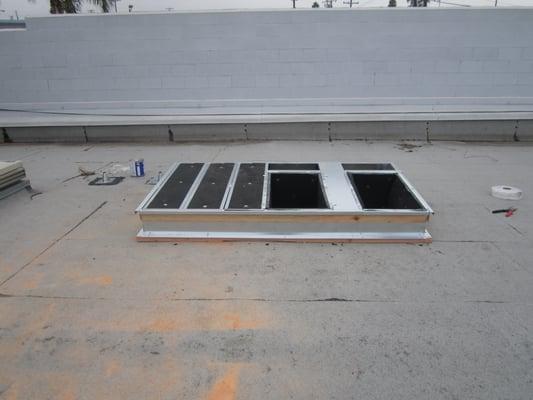 Large 7.5 ton package unit roof curb for an industrial building in Long Beach.