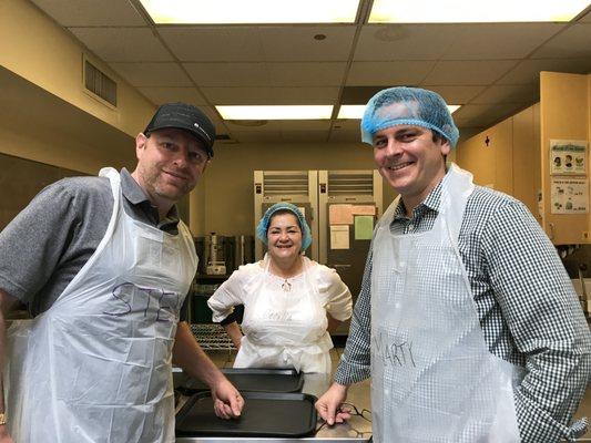 IICF volunteers serving meals to seniors in our dining room!