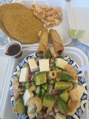 Guerrero-style white pozole, with fried tacos, chopped serrano chili, radishes, avocado, fresh cheese, shredded pork, oil chili sauce.