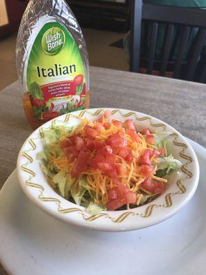 Iceberg lettuce, tomato and cheese salad with a bottle of dressing so you decide how much!