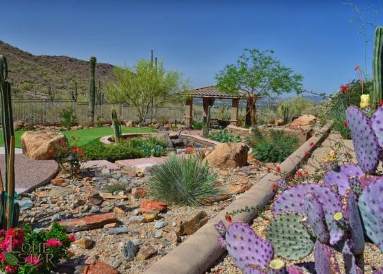 Custom ramada with stacked stone columns.