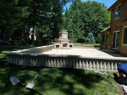 Outdoor Fireplace and seating wall with under-cap lighting. Brighton,Mi