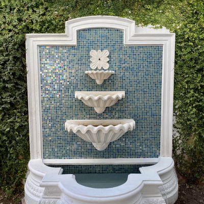 Our Popular 3 tier shell fountain framed with our cast stone moldings and backsplashed with turiquoise ceramic glass.