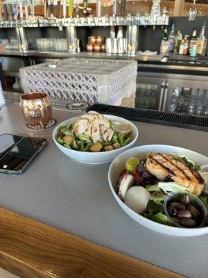 Caesar chicken salad left and Salmon Niçoise salad right