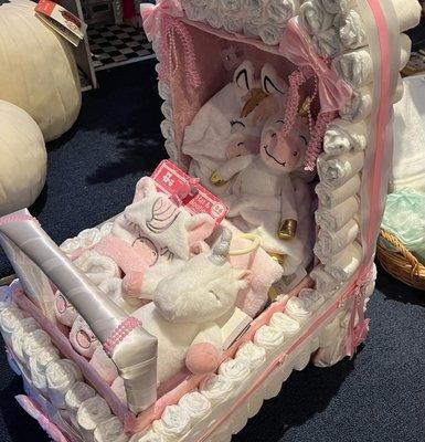 Diaper cake contains unicorn,robe,slippers,blanket,socks and a hat