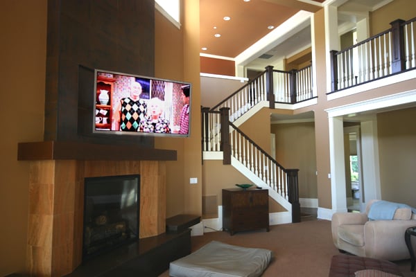 Motorized TV installed over fireplace