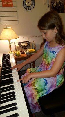 Miss Haylee on the piano at lessons with Mallory