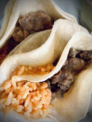 Asada tacos with rice and refried beans