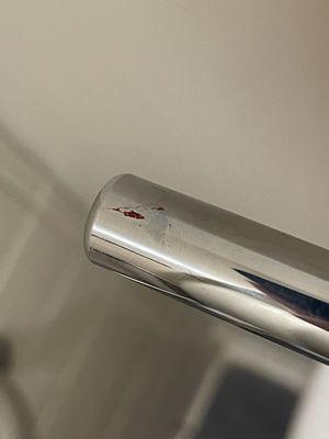 Blood on the handle of toilet, insane because its something everyone has to touch so it is completely unsanitary.