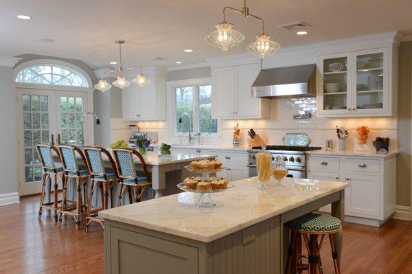 Flush inset, painted cabinetry with imported marble counter tops