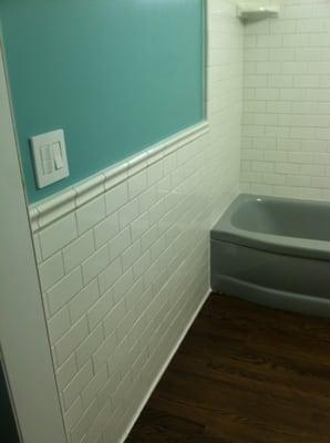 Basic white subway tile with chair rail.