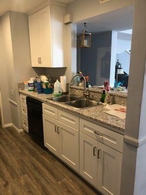 New kitchen cabinets and floor after slab leak.