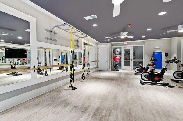 Lotus lounge with exercise bikes, fitness bands, and box jumps at Lantower Weston Corners.