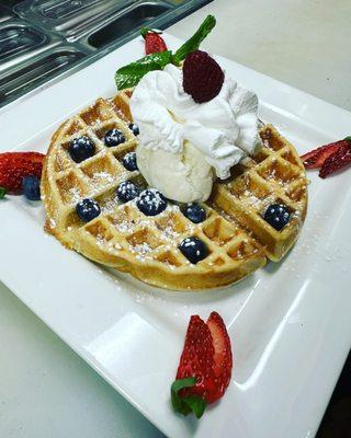 Golden Crispy Waffle w/ vanilla ice-cream , orange butter on the side, fresh fruit & whipped cream.