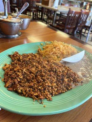 Chorizo con huevo (chorizo and eggs) with refried beans, rice and queso fresco.