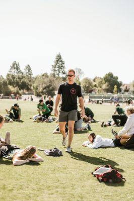 Mike leading a recovery/partner stretching session with the Cal Poly Rugby team.