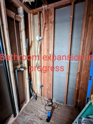 What used to be a hallway closet and a bathroom closet, soon to be new shower in primary bedroom