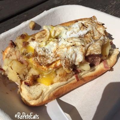 Sick n Twisted hot dog - All beef dog topped with corned beef hash and an over easy egg