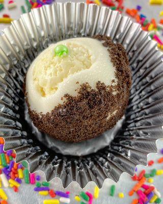 OreO cheesecake dipped in white chocolate and then dipped again in crushed OreO crackers.