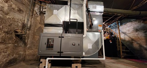 Furnace installation in a low ceiling basement.