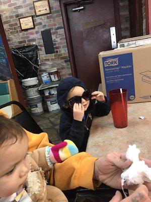 This is my son sitting down waiting for the food. In the background, you can see just how filthy and disgusting this place is.