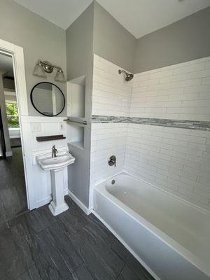 This Bathroom was remodeled and retrofitted with a small pedestal sink.  This allowed room for the built-in linen shelves