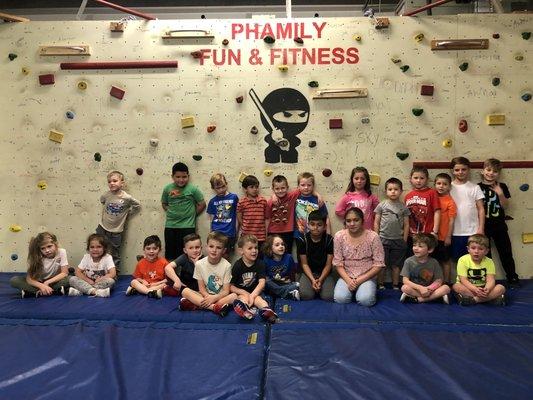 Group birthday photo along the climbing wall - the birthday child gets to sign the wall!