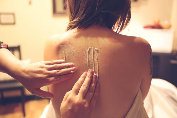 Kaolin clay applied before a detoxifying body wrap.