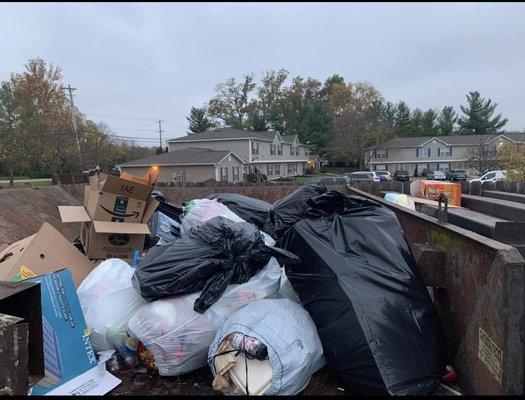 Trash piled on top of compactor