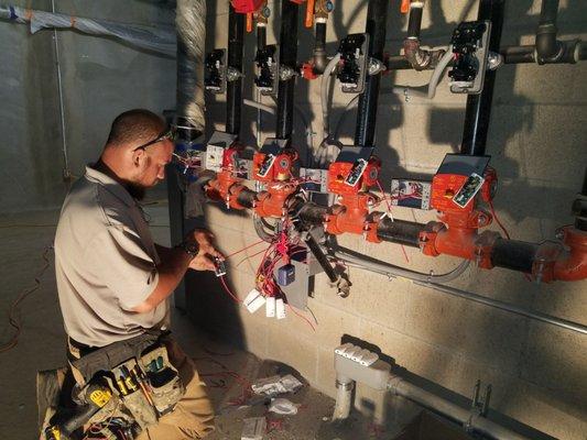 OMD technician preparing an apartment building for sprinkler monitoring.