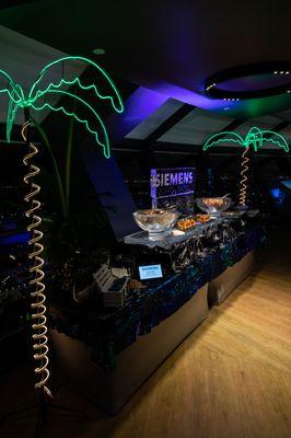 Corporate event buffet setup with LED palm trees & logo ice sculpture