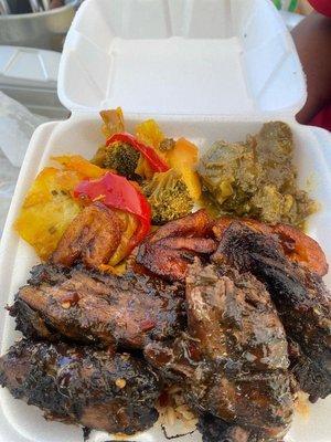 Juicy Jerk Chicken Plate, Veggies, rice & peas, fried plantains & curry eggplant.