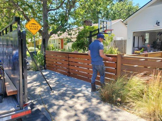 Custom swinging folding gate, iron frame and red western cedar panels installed with Lift Master LA400 gate operator in Kentfield CA