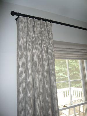 Pinch pleated panels and roman shade