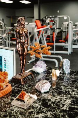 Front desk area with beautiful crystals and a trophy.