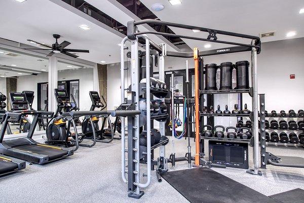 24-hour fitness center with cardio equipment and free weights