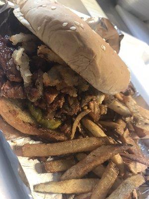 Our baby back rib sandwich: ribs smothered in our honey pecan bbq sauce topped with bread and butter pickles and crunchy onions