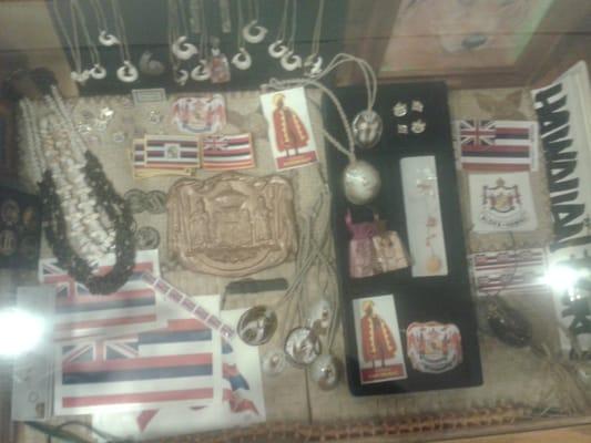 Hooks, shells, necklaces, Hawaiian patches and flags.